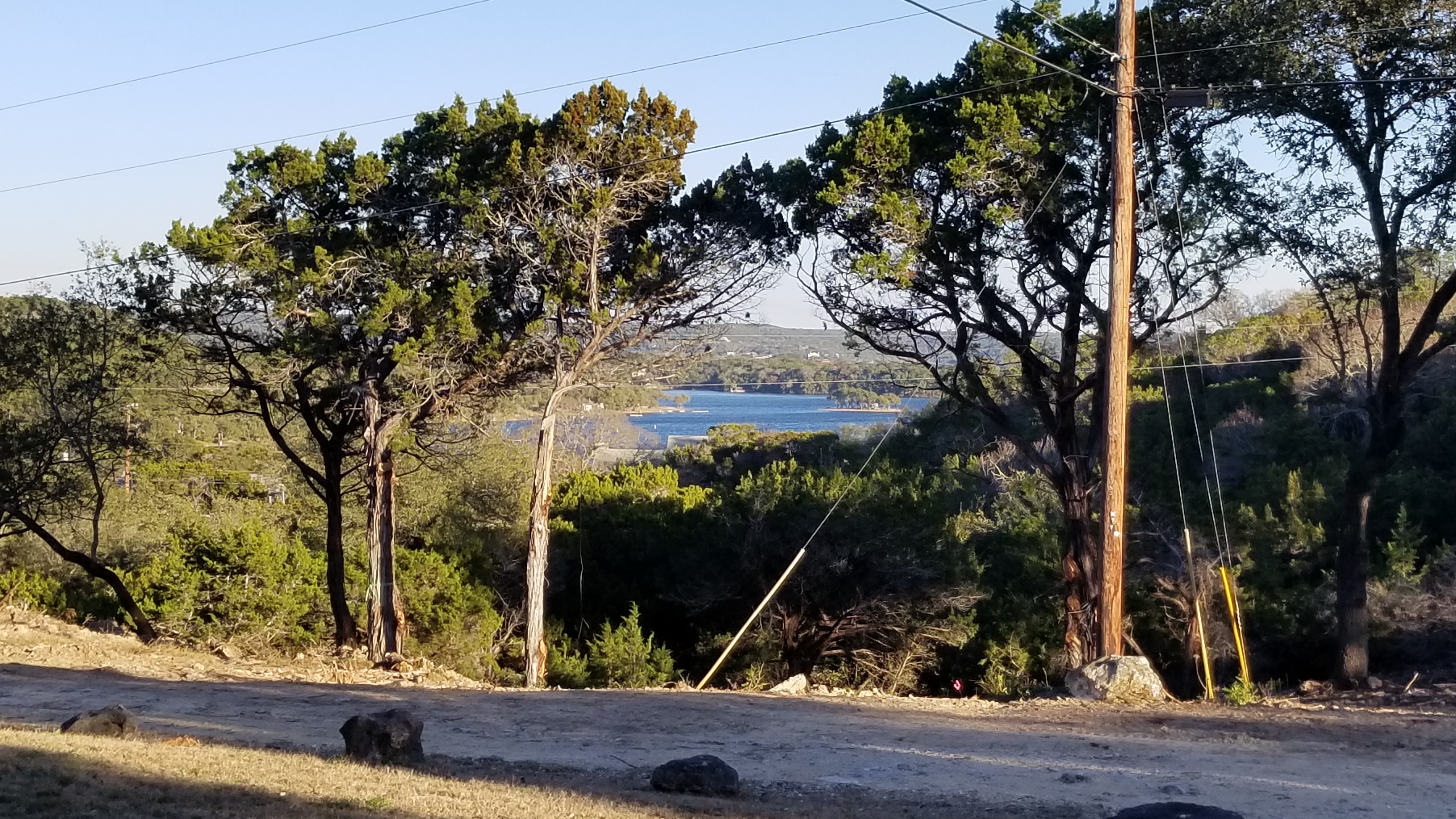 View of Medina Lake through the trees from Medina Highlands Park.